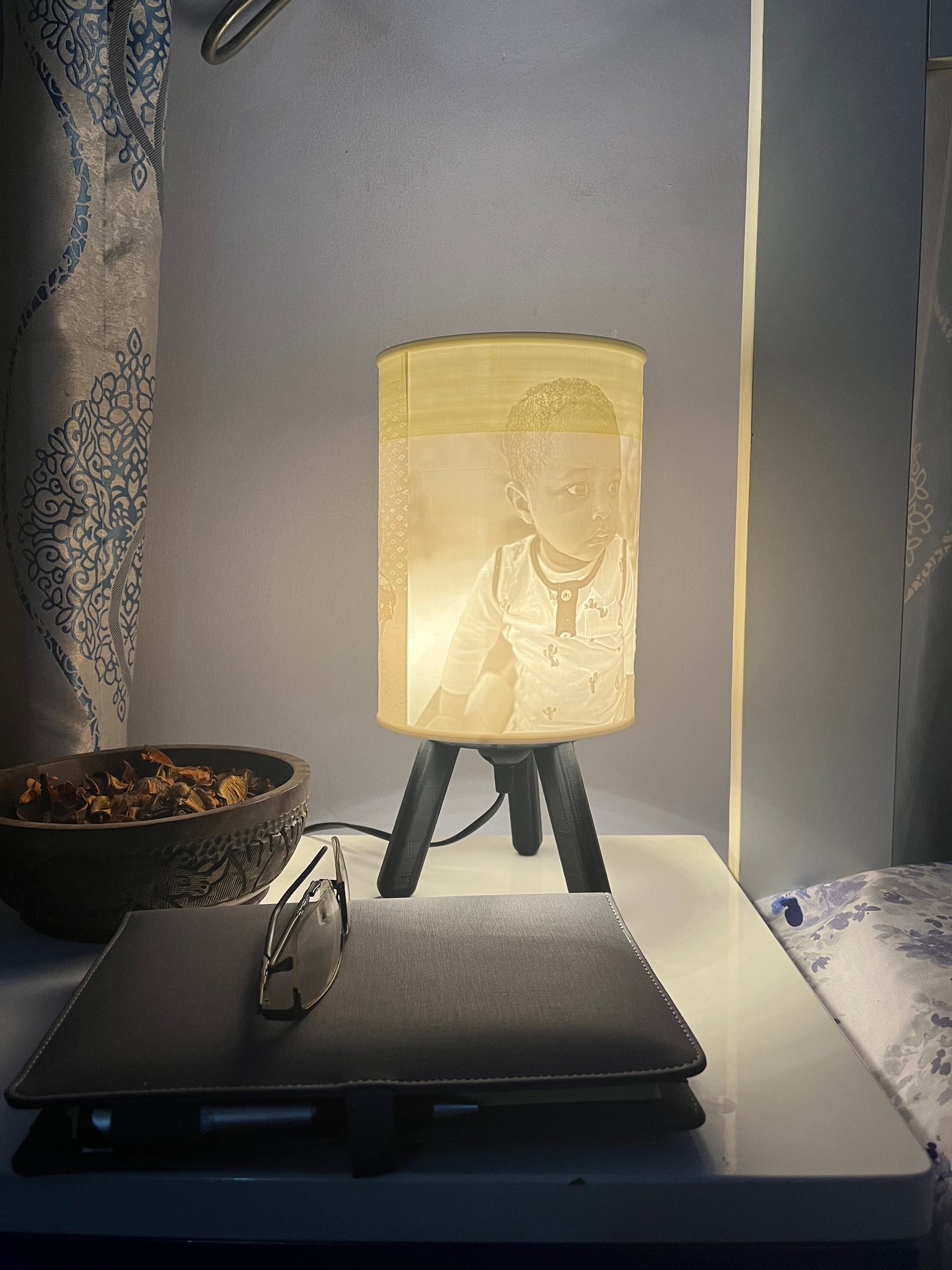 Black 3D printed custom bedside/table lamp on a bedside table
