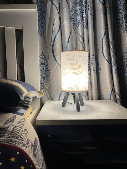 3D printed grey Hako bedside/table lamp on a bedside table