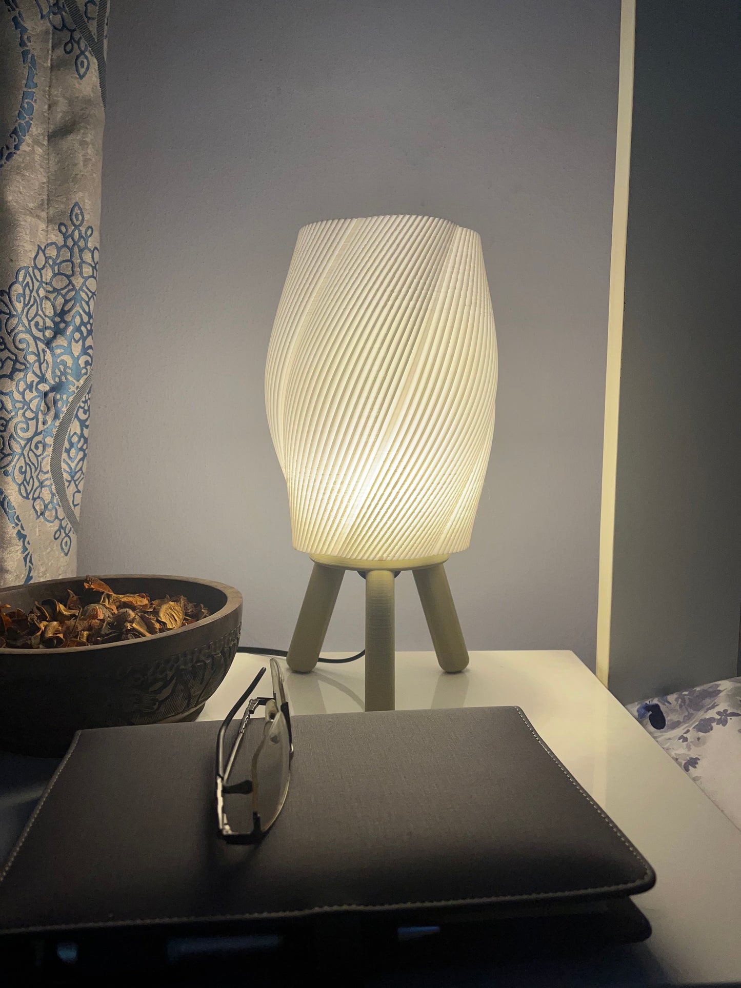 3D printed burlywood Taifū bedside/table lamp on a bedside table