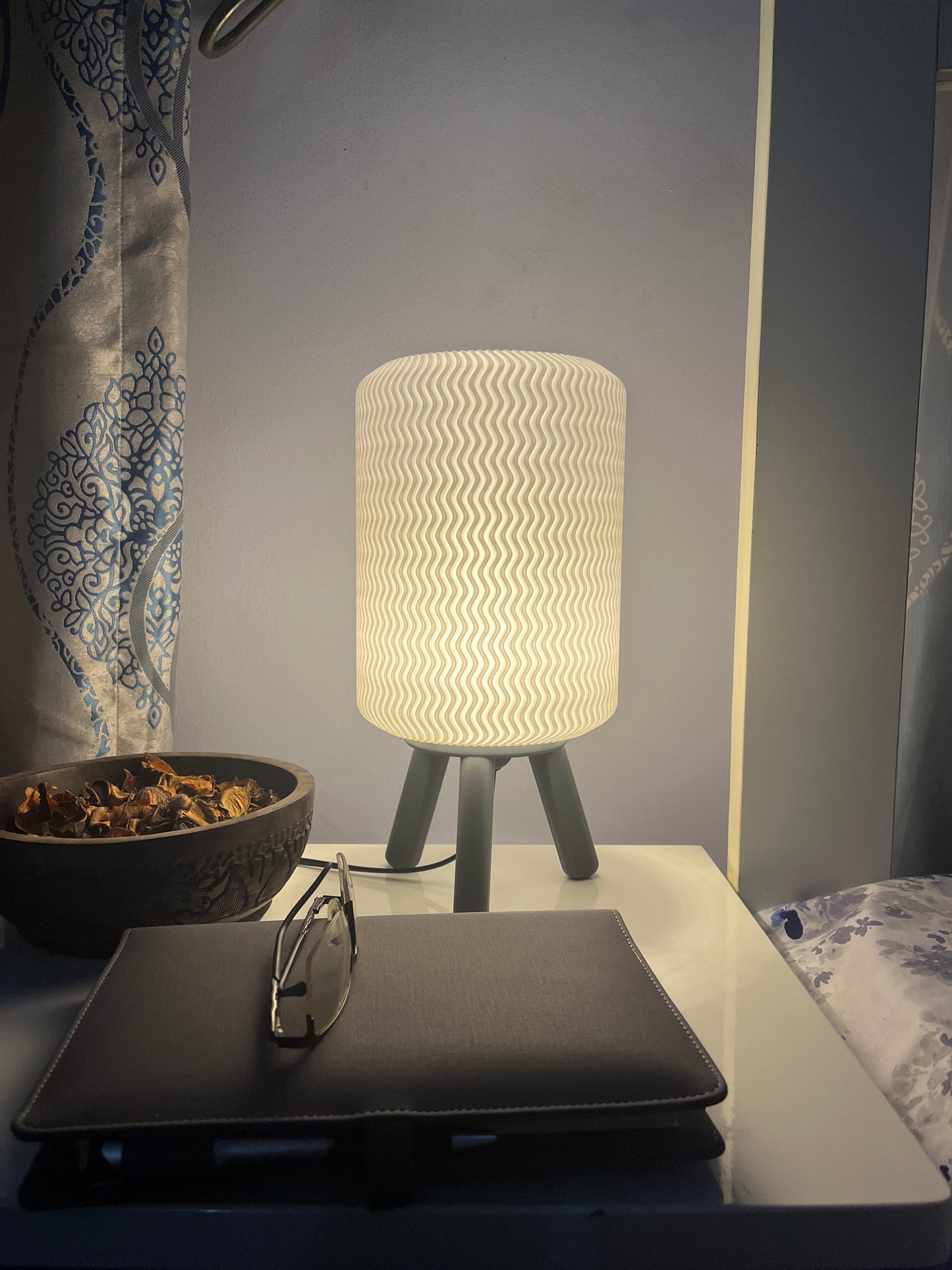 3D printed grey Hajō bedside/table lamp on a bedside table